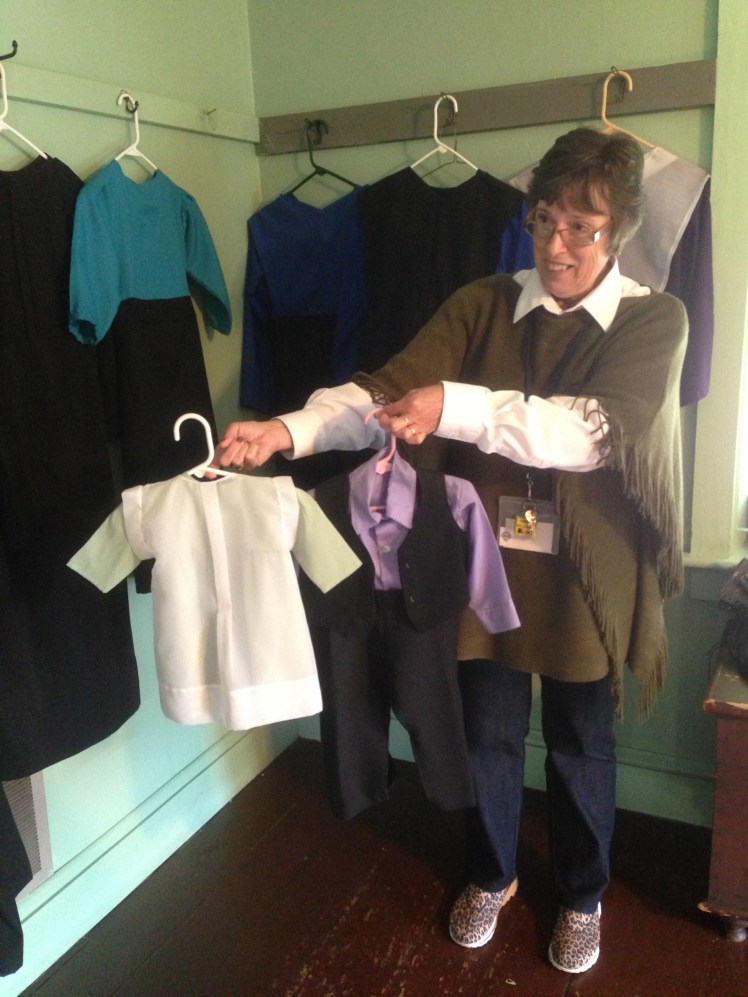our nice tour guide holding some Amish clothings